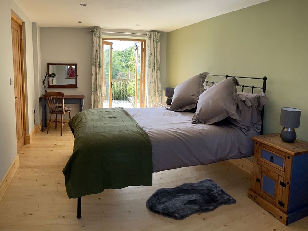 Spacious bedroom with views to the back of In the Hills holiday cottage